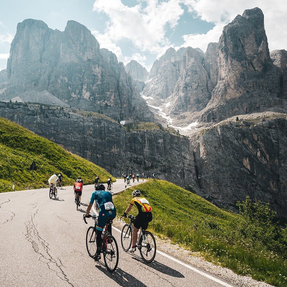The road climbing Passo Pordoi at sunrise, the Sella massif behind