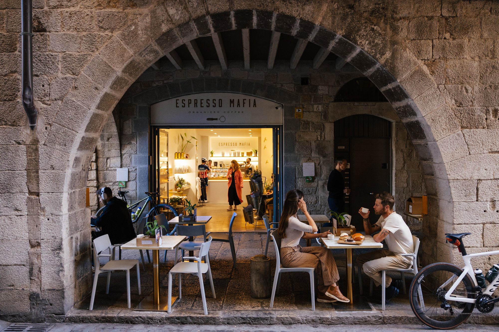 Cyclists at a café in Girona's old town