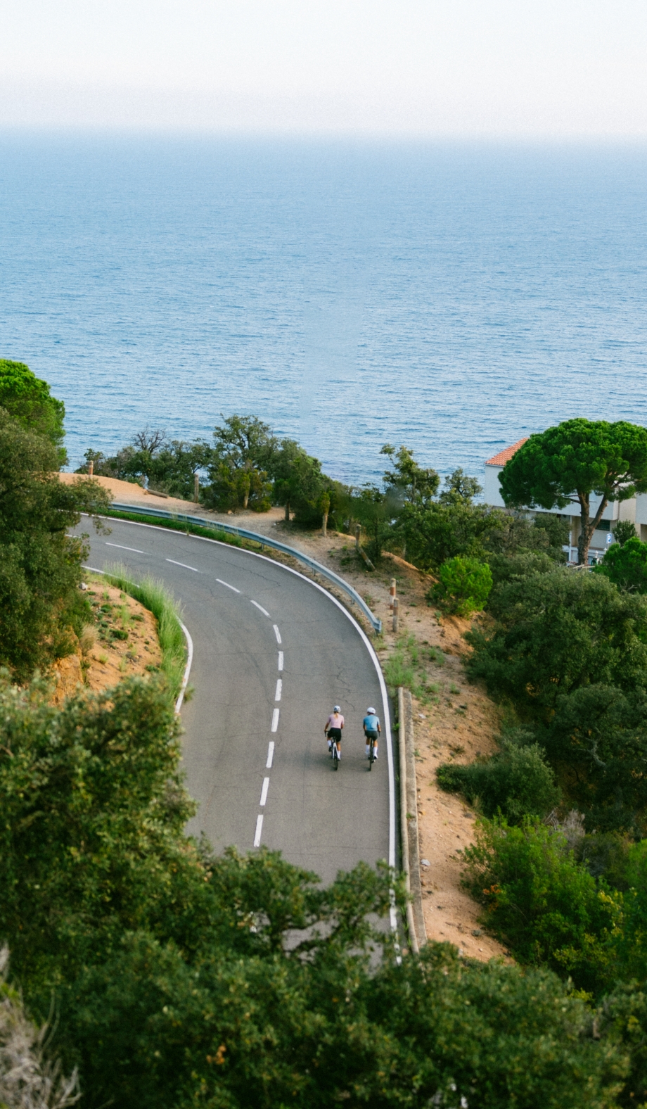The GI-682 coast road, sea below and cliffs above