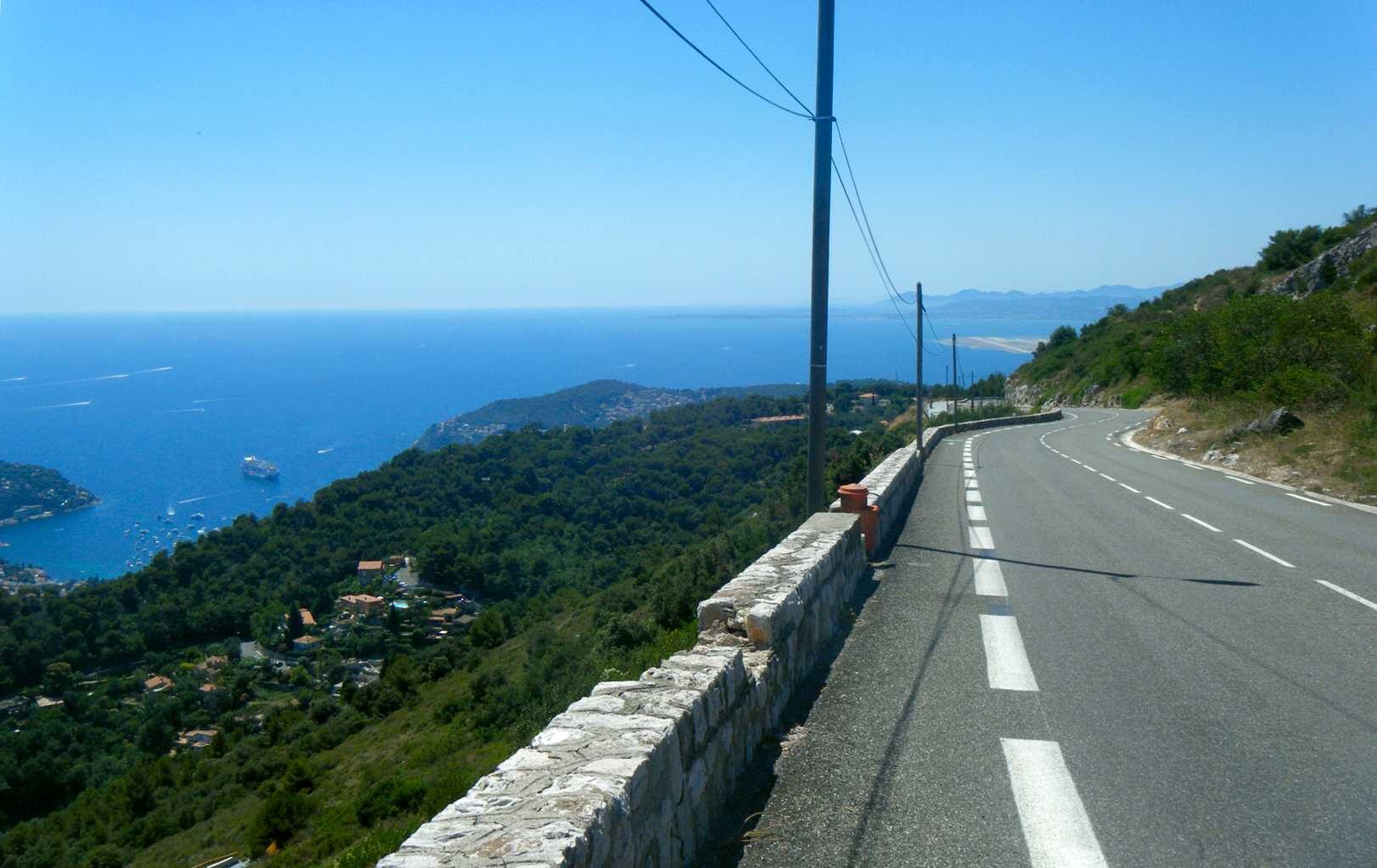 The Col d'Èze road winding above the coast with the village of Èze on its crag and the Mediterranean below